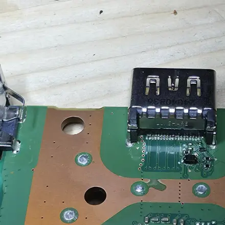 A replacement HDMI port soldered onto a PlayStation 5 board by us2you, seen under the microscope.